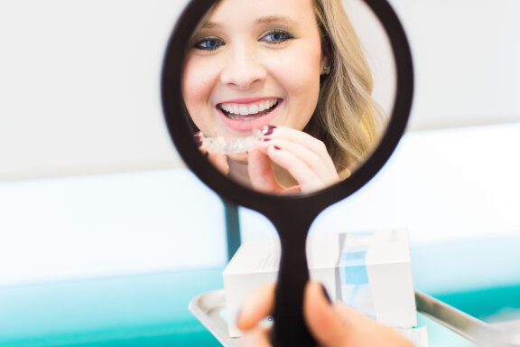 Patient Reflected in Handheld Mirror